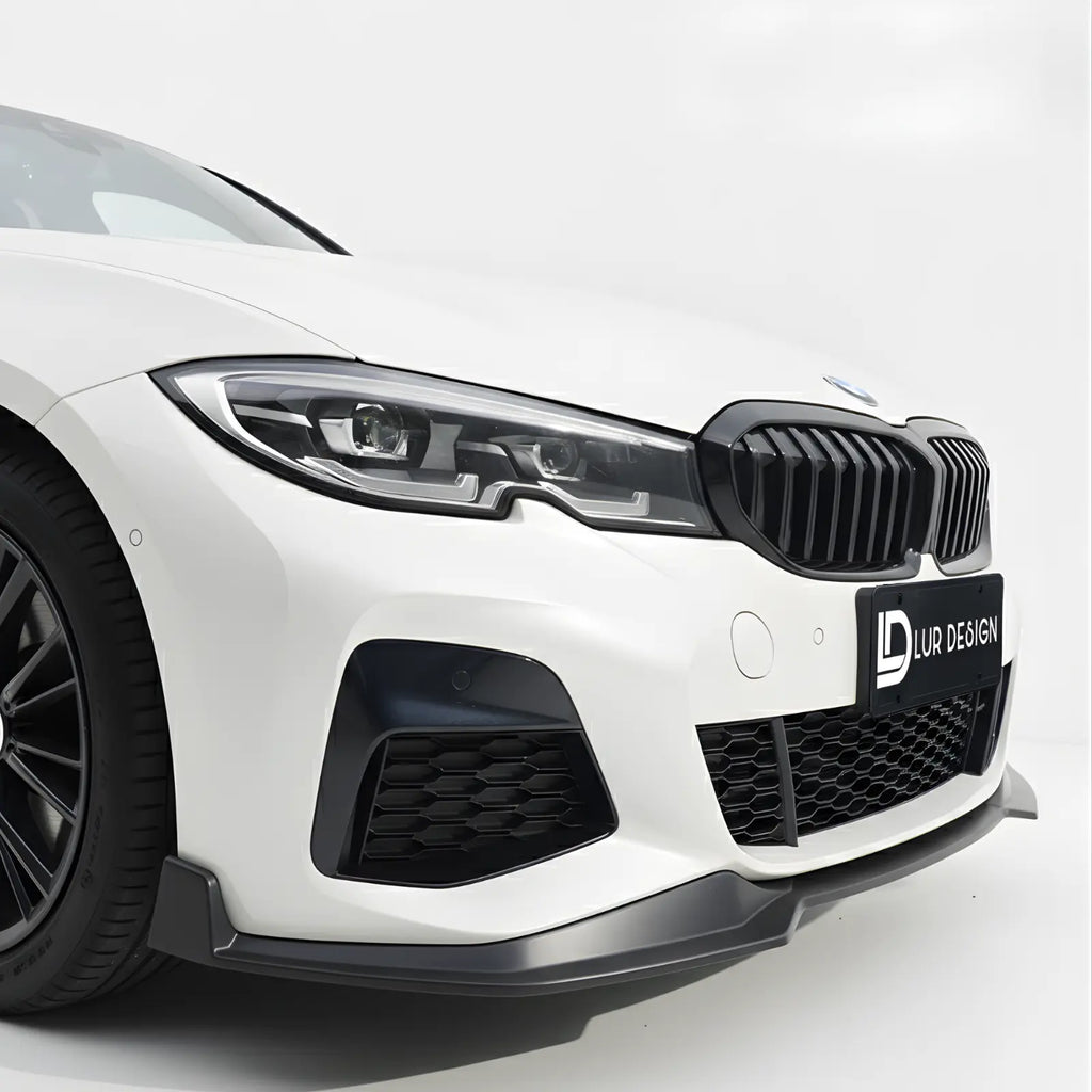 Front Lip splitter for BMW Series 3 G20 1 Close-up of a white car's front grille with a black grille and visible branding on a white background.
