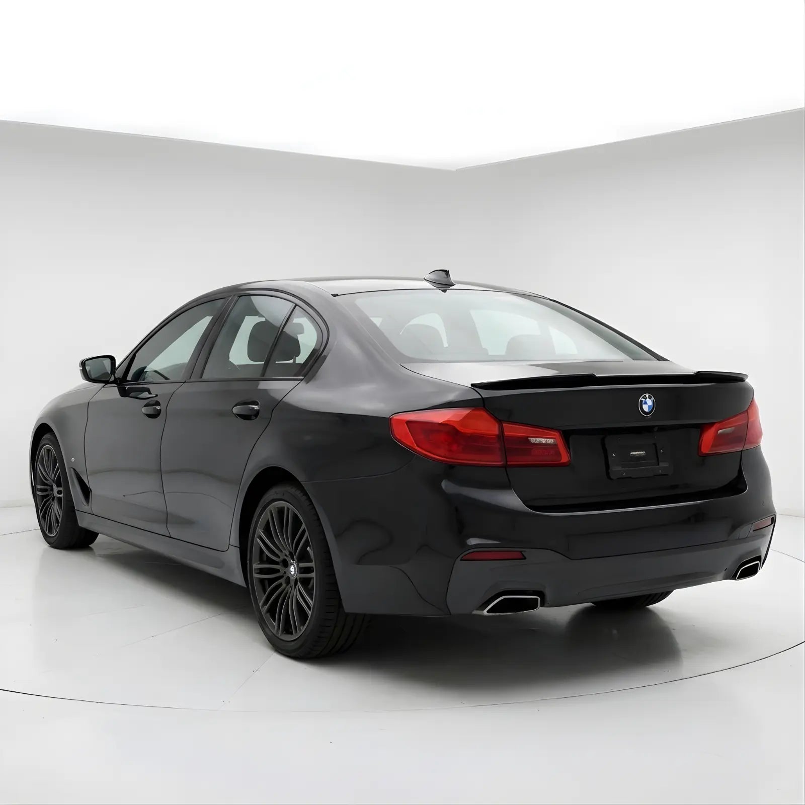 BMW_Series_5_g30_spoiler_2 duckbill spoiler lip
Black BMW car on a white background