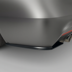 Close-up of a car's rear side splitters on a gray background